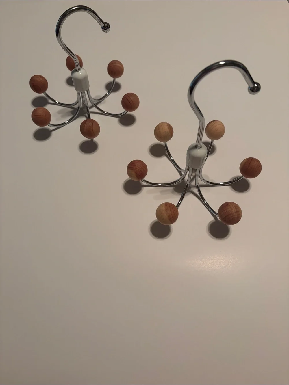 Chrome multi-hook hanger with round cedar wooden knob ends.